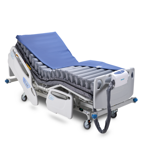 Wellell Domus Auto Medical Air Mattress on a hospital bed, featuring alternating pressure redistribution and quilted cover.