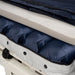 A close-up view of the Proactive Protekt 1st Defense mattress system displaying the individual air bladders and a layer of foam within its blue and white cover, unzipped to reveal the internal structure
