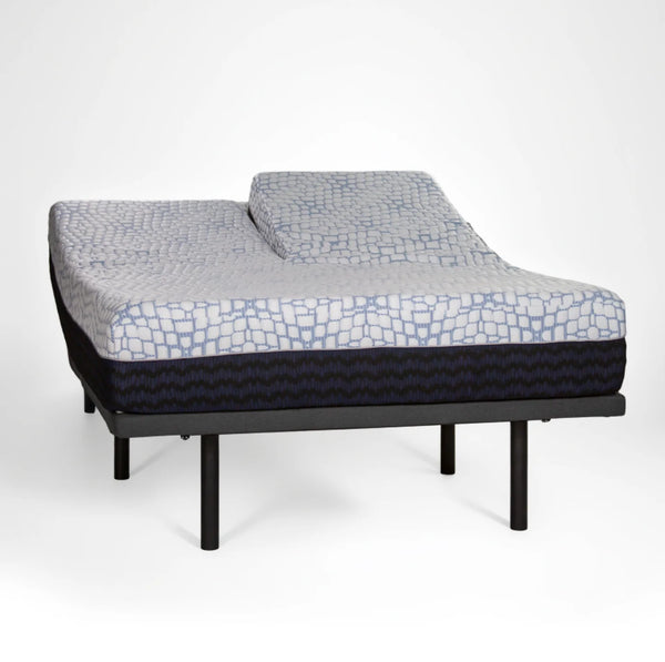 A perspective view of the Bliss Hybrid on an adjustable base with a "split head" configuration. One side of the upper mattress is elevated while the other remains flat.
