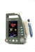 Protekt VX 5000 vital signs monitor powered on, showing blood pressure, SpO₂, pulse rate, and temperature readings on a bright color display