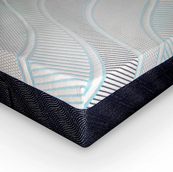 A high-angle close-up of the mattress corner, showcasing the transition between the wavy, striped top fabric and the dark navy blue side wall.