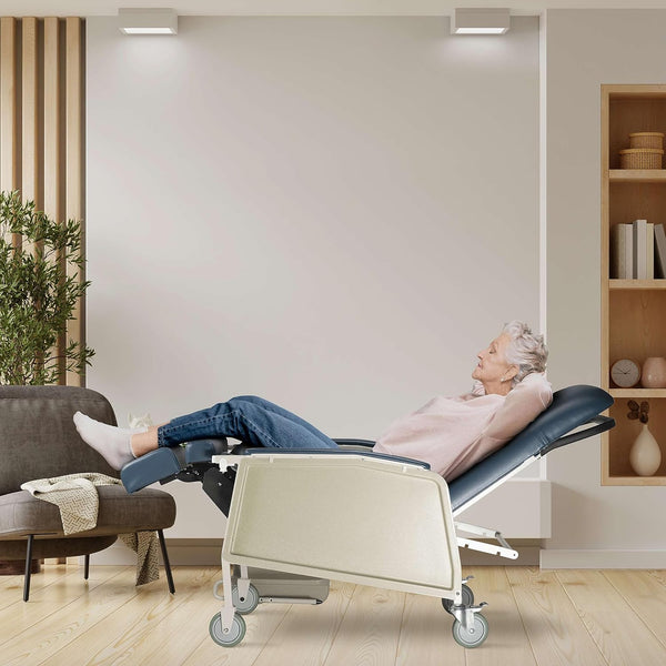 Geri chair with blue upholstery in reclined position, showing foot rest and locking casters with an elderly woman relaxing with her eyes closed