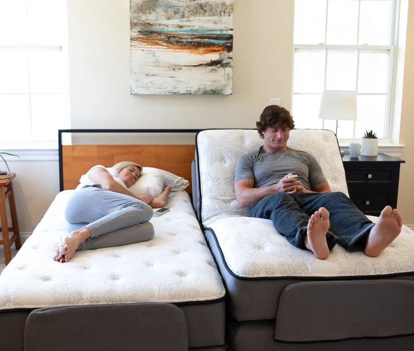 Couple on dual Flexabed Premier adjustable beds, one side reclined for reading and the other flat for sleeping
