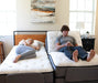 Couple on dual Flexabed Premier adjustable beds, one side reclined for reading and the other flat for sleeping