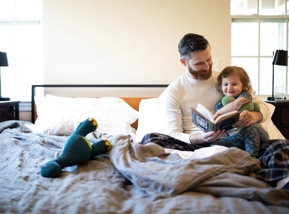 Father reading to child on a Flexabed Premier adjustable bed, emphasizing comfort, relaxation, and quality time