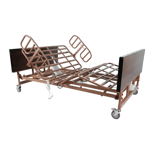 A Protekt Akra full electric bariatric hospital bed with a brown metal frame  with the head and foot sections elevated, wood-grain head and footboards, and half-length side rails. It is equipped with locking casters and a hand pendant controller hanging from the side.