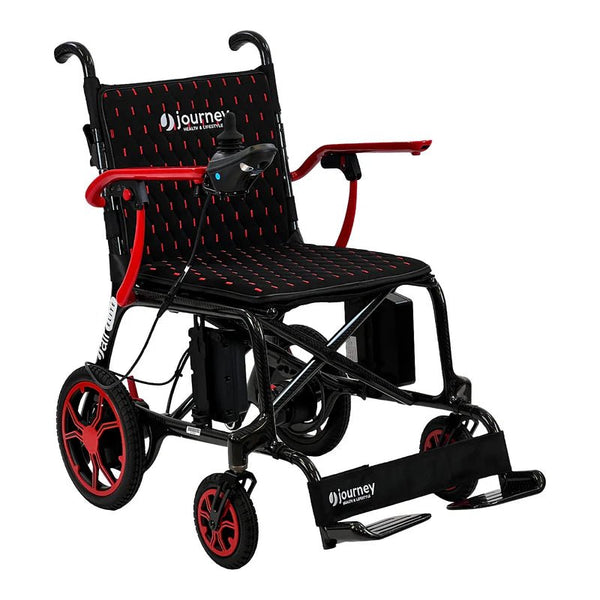 A studio portrait of the Journey Air Elite wheelchair with bold red accents on the armrests, wheel rims, and the stitching on the black mesh seat and backrest.