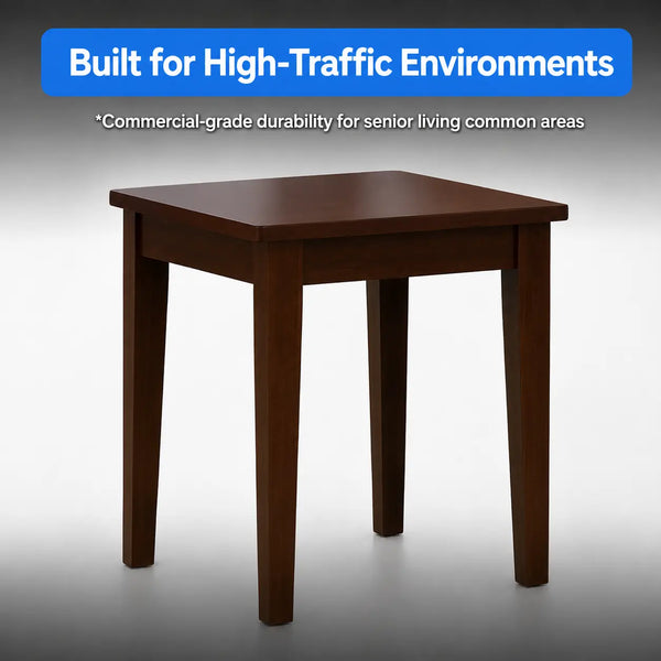 A square wooden table with four legs in a dark brown finish, shown against a gray gradient background with a blue text banner at the top that reads 'Built for High-Traffic Environments'.