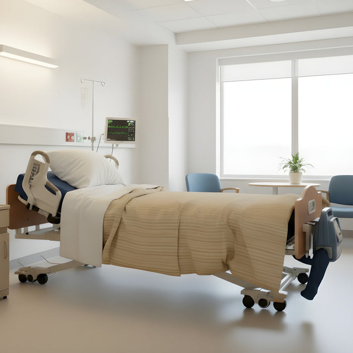 A Joerns DolphinCare bed in a sterile, white hospital room, fully made with white sheets and a beige striped comforter. The blue DolphinCare control unit is attached to the footboard.