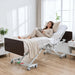 Fully electric expandable hospital bed for home use - Emerald Oasis 52300 with hi-low adjustment, adjustable backrest, dark espresso headboard, white metal Double Y frame, and central locking casters shown in a modern home bedroom setting.