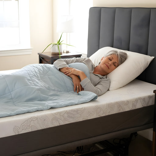 Older woman peacefully sleeping on a Flexabed Hi-Low adjustable bed with an optional mattress, head slightly elevated for comfort