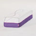 The standalone mattress extension bolster at an angle, displaying the breathable purple mesh sides and the contour-matching top fabric.