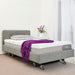 Icare IC333 in Smoke with headboard, IC30 mattress, an Icare pillow, and a purple blanket in a room with white walls and curtains.