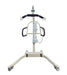 Front view of the Free Spirit True Bariatric Patient Lift FS850 in beige and black, with a wide base, wheels, handlebars, and sling hooks—designed for safe mobility and transfers in healthcare environments.
