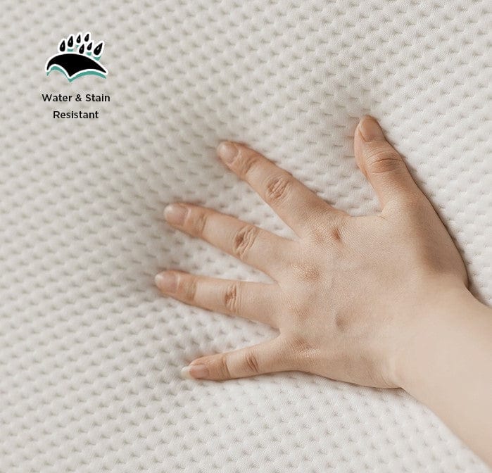 A hand presses on the soft, white surface of the Starsleep Orin Rotating Bed—ideal for luxury adjustable beds. A water & stain resistant symbol and text are shown in the top left corner.