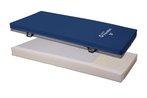Joerns PrevaMatt Defend pressure relieving mattress, showing the fluid-resistant blue cover alongside the exposed, segmented foam core base with pressure redistribution cuts.