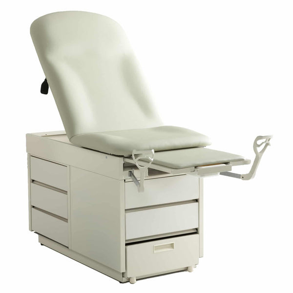 A Graham-Field Hausted 4200 Series manual exam table againt a plain white background. The table features a multi-positional padded top, integrated storage drawers on the side and front base, and extendable stirrups and leg rest for patient positioning.