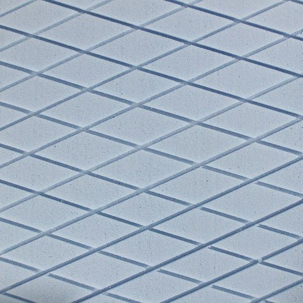 Close-up macro detail of the die-cut surface foam texture of the Protekt 300 pressure redistribution mattress, showing the diamond pattern designed for clinical pressure relief.