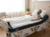 Man resting comfortably on a Protekt 600 Bariatric Foam Mattress in a hospital bed