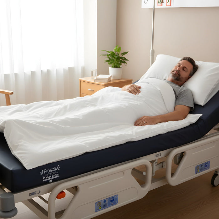 Man resting comfortably on a Protekt 600 Bariatric Foam Mattress in a hospital bed