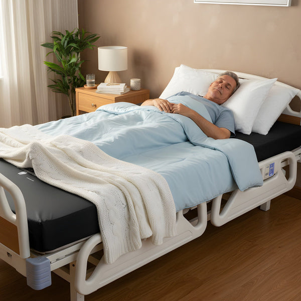 An elderly man sleeping comfortably on a 54" Protekt 600 Bariatric Foam Mattress installed in a hospital bed