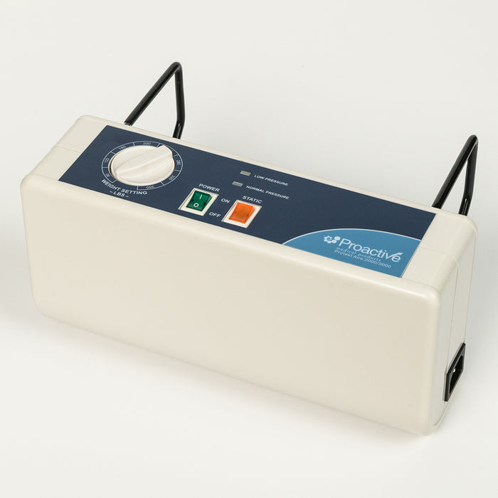 A Proactive Protekt Aire 2000/3000 pump with black metal hanging hooks attached. The pump's white casing and blue control panel are visible, featuring a weight setting dial, power switch, static button, and pressure indicators. The power input port is on the right.