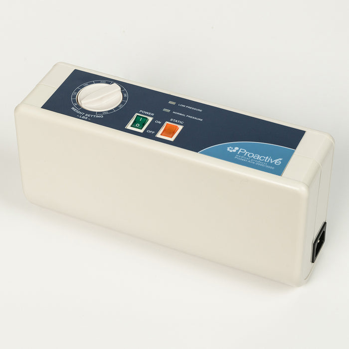 An angled view of the Proactive Protekt Aire 2000/3000 pump, highlighting the white casing, blue control panel with a weight setting dial, power switch, static button, and pressure indicators. The power input port is visible on the right side.