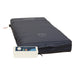 The Protekt Aire 3500 Low Air Loss dark blue air mattress for hospice beds features an alternating pressure system and control unit. Its cover shows outlined footprints and head/foot labels. Photo: mattress on a white background.
