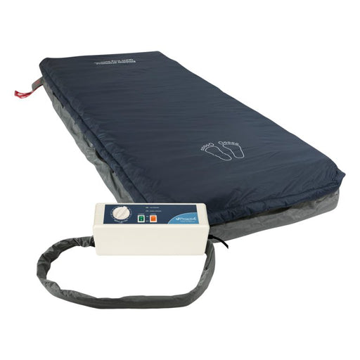 Protekt Aire 3600 system full mattress view displaying the dark blue low air loss mattress with foot outline marking, connected to white control unit via flexible air tubing