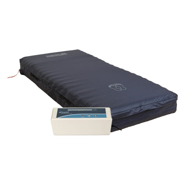 Protekt Aire 5000DX system full mattress view displaying the dark blue low air loss mattress with foot outline marking, connected to white control unit via flexible air tubing