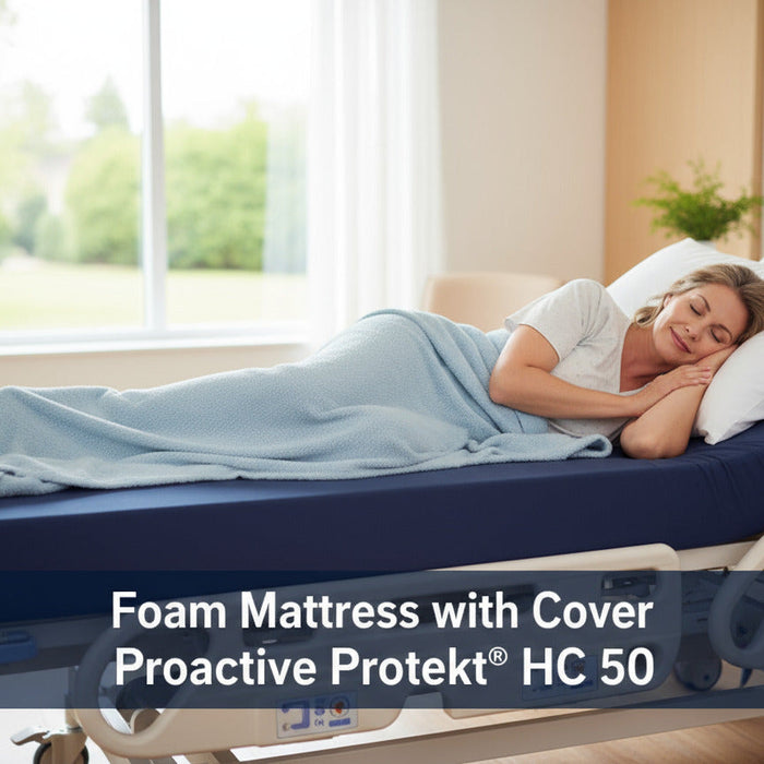 A woman sleeps on her side in a hospital bed, covered by a light blue blanket. She is lying on the dark blue Proactive Protekt HC 50 foam mattress with cover. Overlay text reads: "Foam Mattress with Cover Proactive Protekt® HC 50"