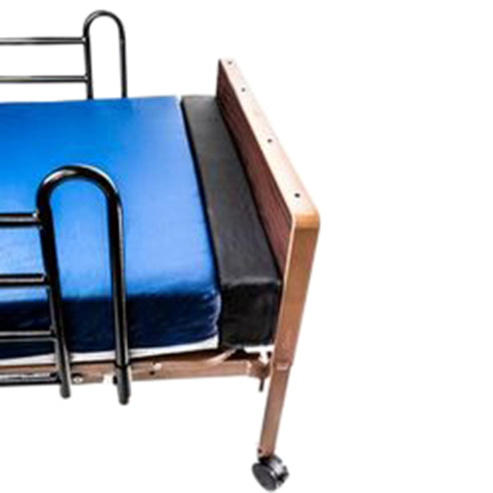 An isolated close-up of a Protekt Mattress Extender, a black foam block used to bridge the gap between a mattress and the footboard of a bed, thereby lengthening the sleep surface.