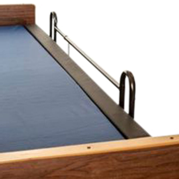 An isolated close-up of a Protekt Rail Guard. It is a black, padded bumper attached to a metal bed rail, designed to cover the side rail gap and prevent patient entrapment.