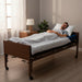 Man resting on the Protekt Supreme Support extra tall self-adjusting mattress system for enhanced comfort and pressure relief on a hospital bed