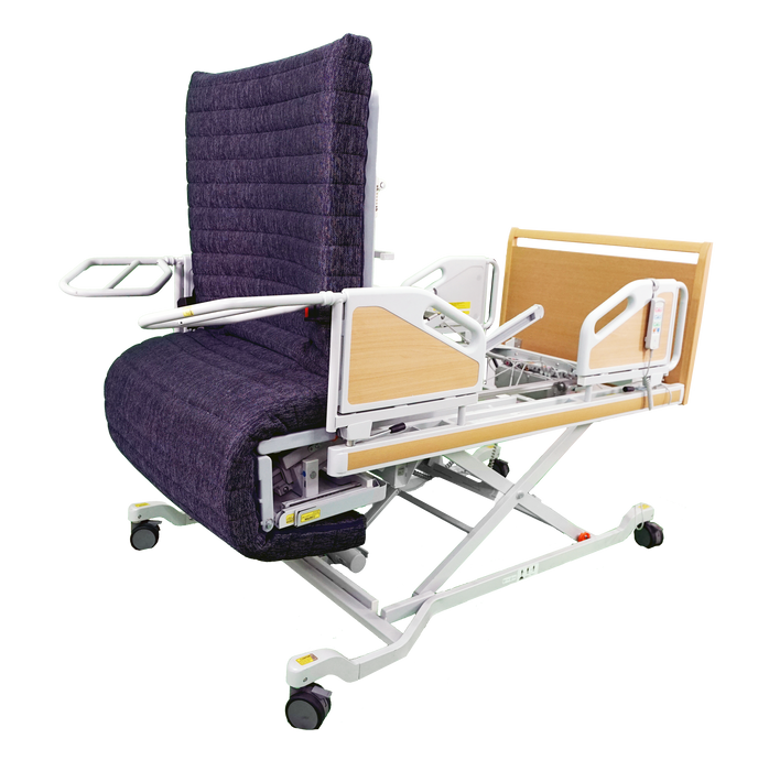 The ReNuCare Standing Bed is a 4-position adjustable hospital bed with a purple padded recliner, white metal frame, armrests, wooden head/foot panels, and wheels for easy mobility—ideal for patient care.
