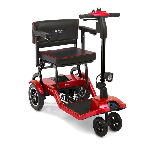A vibrant red Journey So Lite® power scooter shown from a front-three-quarter angle. The image displays the four-wheel design (with two close-set front wheels), padded armrests, a black cushioned seat with red piping, and the adjustable steering tiller.