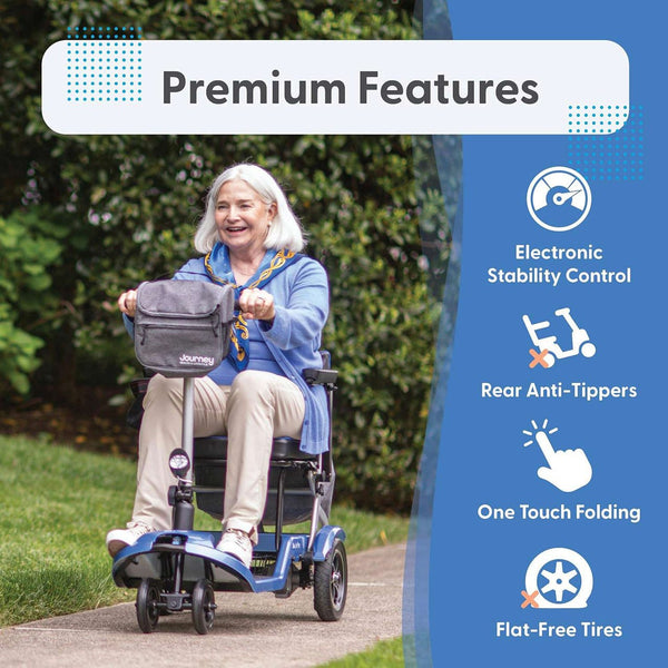 A senior woman is riding comfortably on blue Journey So Lite mobility scooter outdoors with 'Premium Features' badge highlighting Electronic Stability Control, Rear Anti-Tippers, One Touch Folding, and Flat-Free Tires.