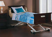 Joerns UltraCare XT hospital bed shown in a home setting with head and foot boards in Cordovan finish, blending into the bedroom decor. The bed is covered with blue and white bedding.