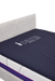 A high-angle view of a dark blue ActiveFloat medical mattress overlay lying flat on top of a white mattress and an upholstered bed frame, with the "icare Medical Group" logo visible on the surface.