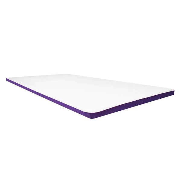 A clean, isolated, angled shot of the white ActiveX mattress overlay, highlighting its smooth surface and purple edge trim against a plain white background.