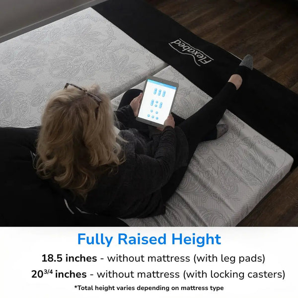 Flexabed Hi-Low SL adjustable home care bed shown at fully raised height with a person using a tablet, illustrating maximum height position and listed height measurements without a mattress.