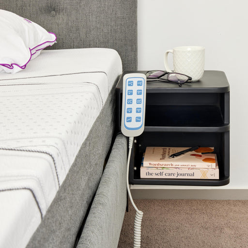 A compact, two-tier shelf unit finished in matte black. It is designed to mount directly to the Icare bed frame, serving as a floating nightstand.