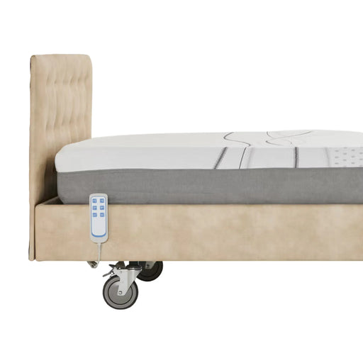 iCare IC111 homecare bed side view showing backlit wired hand control, padded headboard, IC30 mattress, and heavy-duty lockable castor wheel in dove upholstery