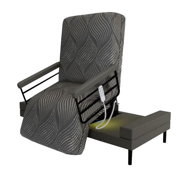 The Independence Bed Adjustable Bed for Seniors by Journey Health & Lifestyle features a black and gray wavy cover, raised backrest, black armrests, remote control on the side, and sits elevated on a platform base for improved fall prevention.