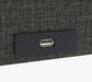Close-up of a USB port on The Independence Bed Adjustable Bed for Seniors by Journey Health & Lifestyle—conveniently built into a black panel on textured fabric, offering comfort and fall-prevention features for senior safety.