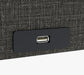Close-up of a USB port on the UPbed Independence Adjustable Bed for Seniors by Journey Health—conveniently built into a black panel on textured fabric, offering comfort and fall-prevention features for senior safety.