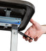 Hand operating black height adjustment lever mechanism underneath composite tabletop surface