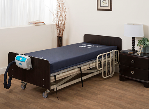 Blue-covered hospital bed with the Medacure Low Air Loss Mattress AW700.