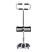 The Assist & Turn Sit to Stand Transfer Aid is an adjustable white transfer device with black accents, featuring a handlebar, knee support, and wheeled platform to help individuals stand and move safely.
