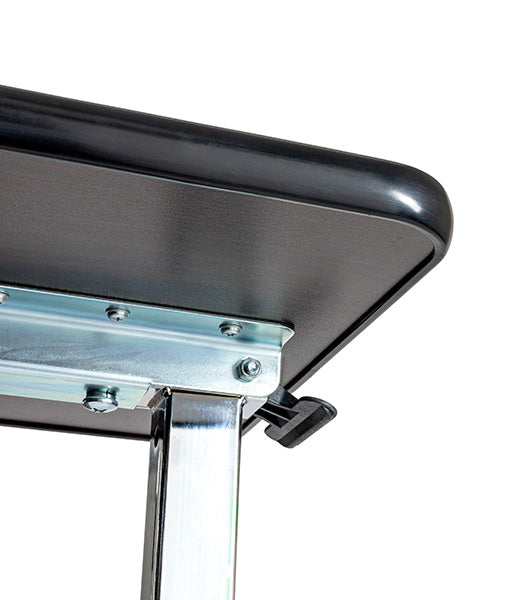 Close-up view of an overbed table's height adjustment lever in the locked position, showing the wooden tabletop surface and steel base construction
